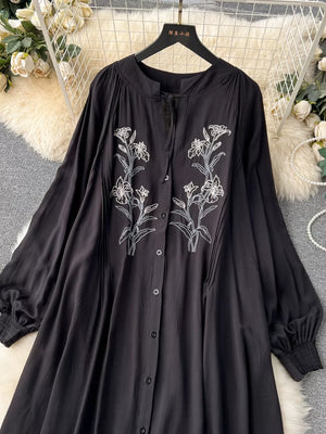 Black embroidered floral maxi dress with tie neck and balloon sleeves.