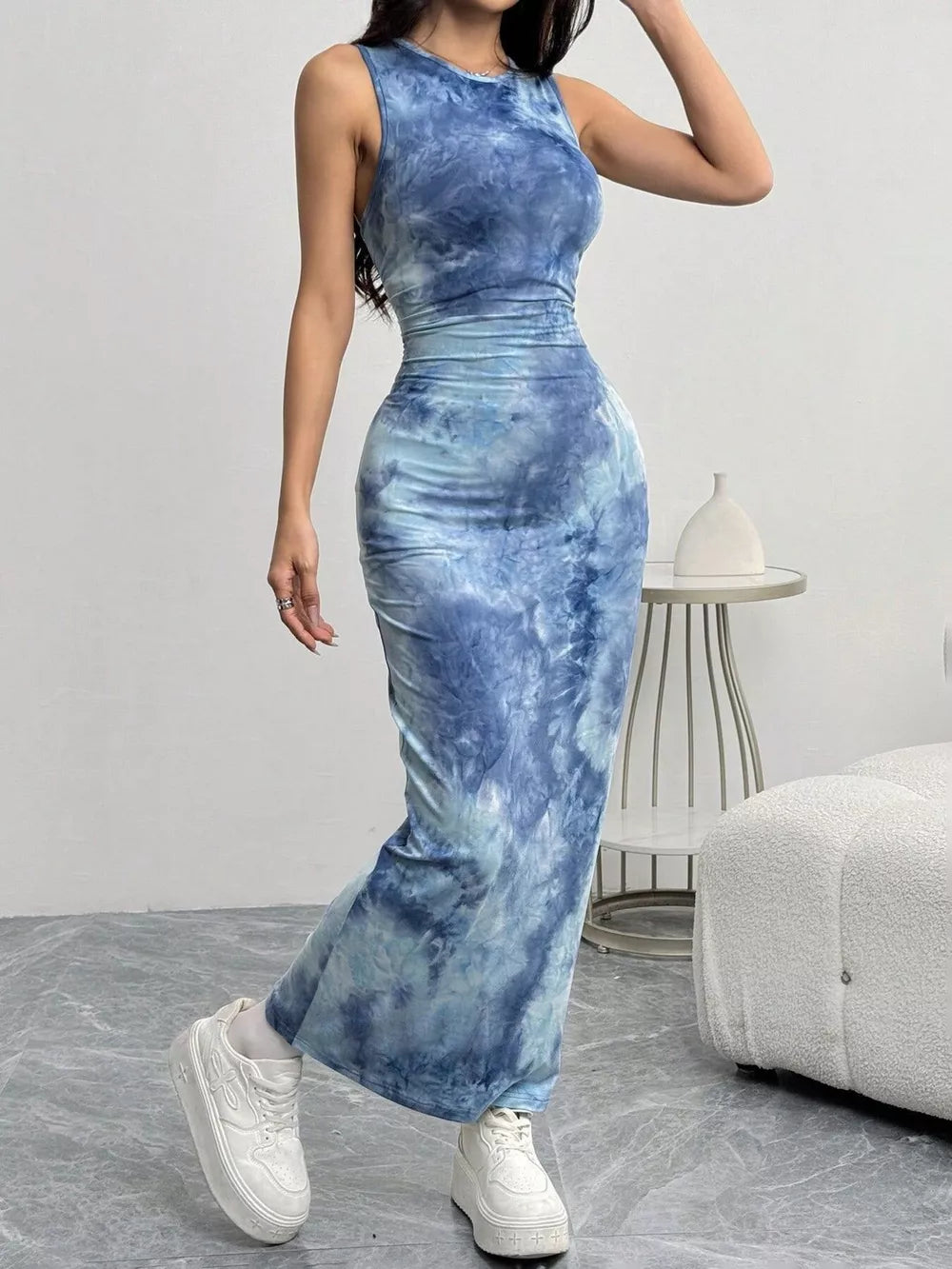 Vibrant tie-dye maxi dress in sea blue with a bodycon fit and sleeveless design.