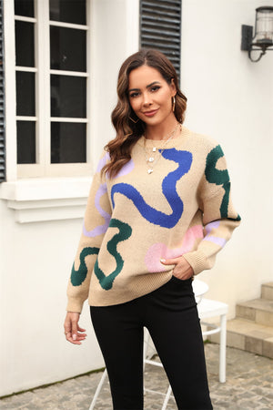 Tan abstract swirl knit crewneck sweater with blue, purple, green, and pink accents.