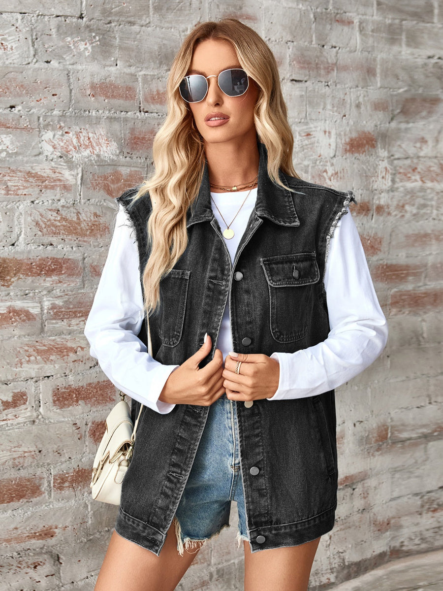 Black raw-edge denim utility vest with button front and chest pockets.