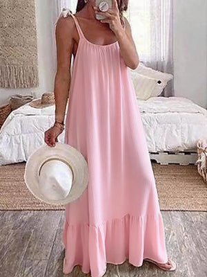 Pink tie strap maxi dress with ruffled hem and subtle vertical texture.