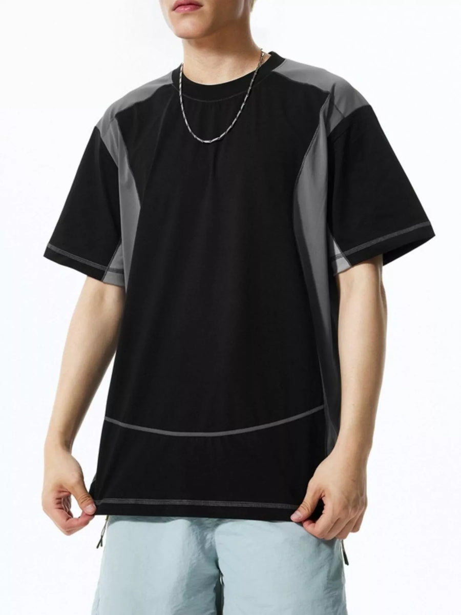 Black t-shirt with grey paneling and contrast stitching, relaxed fit, crew neck, short sleeves.