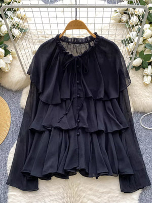 Black chiffon blouse with tiered ruffles, bow tie neckline, and button front.