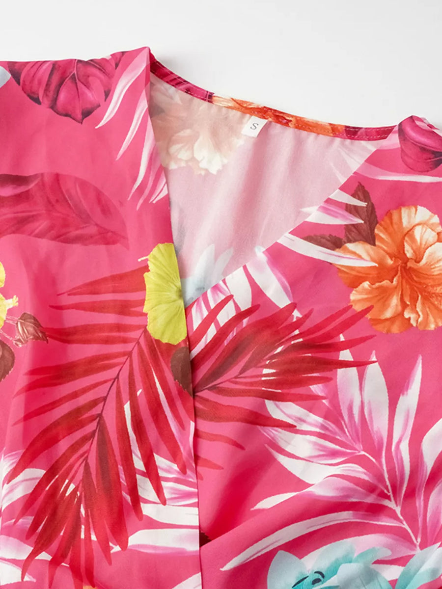 Hot pink tropical print midi dress with V-neck and pleats.