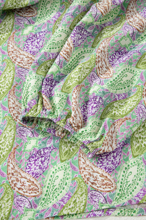 Paisley print puff sleeve blouse with elastic cuff in green, purple, and cream.