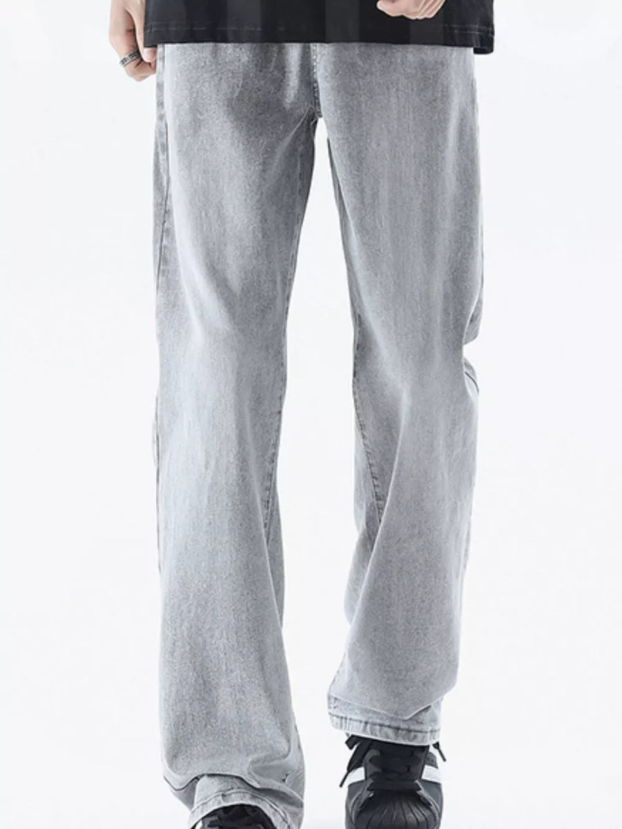 Men's relaxed fit light grey denim jeans with a vintage wash.