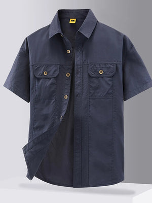 Dark blue cotton button-down shirt with short sleeves and two chest pockets.