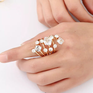 Glamorous multi-layered gold-plated ring with clear crystals.