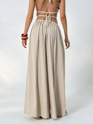Textured wide-leg maternity pants in beige with a gathered waist and drawstring detail.
