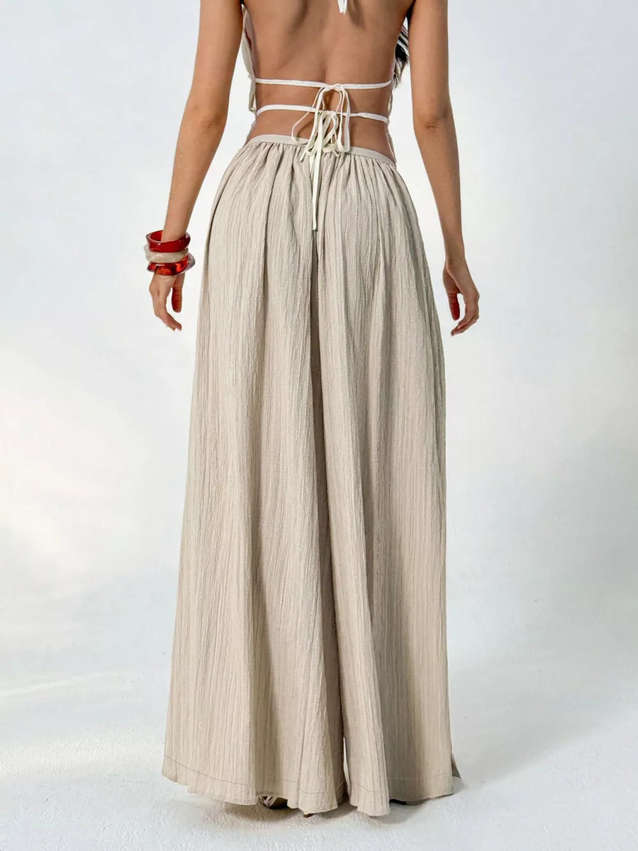 Textured wide-leg maternity pants in beige with a gathered waist and drawstring detail.