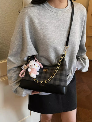 Chic plaid shoulder bag with chain accent and Hello Kitty charm
