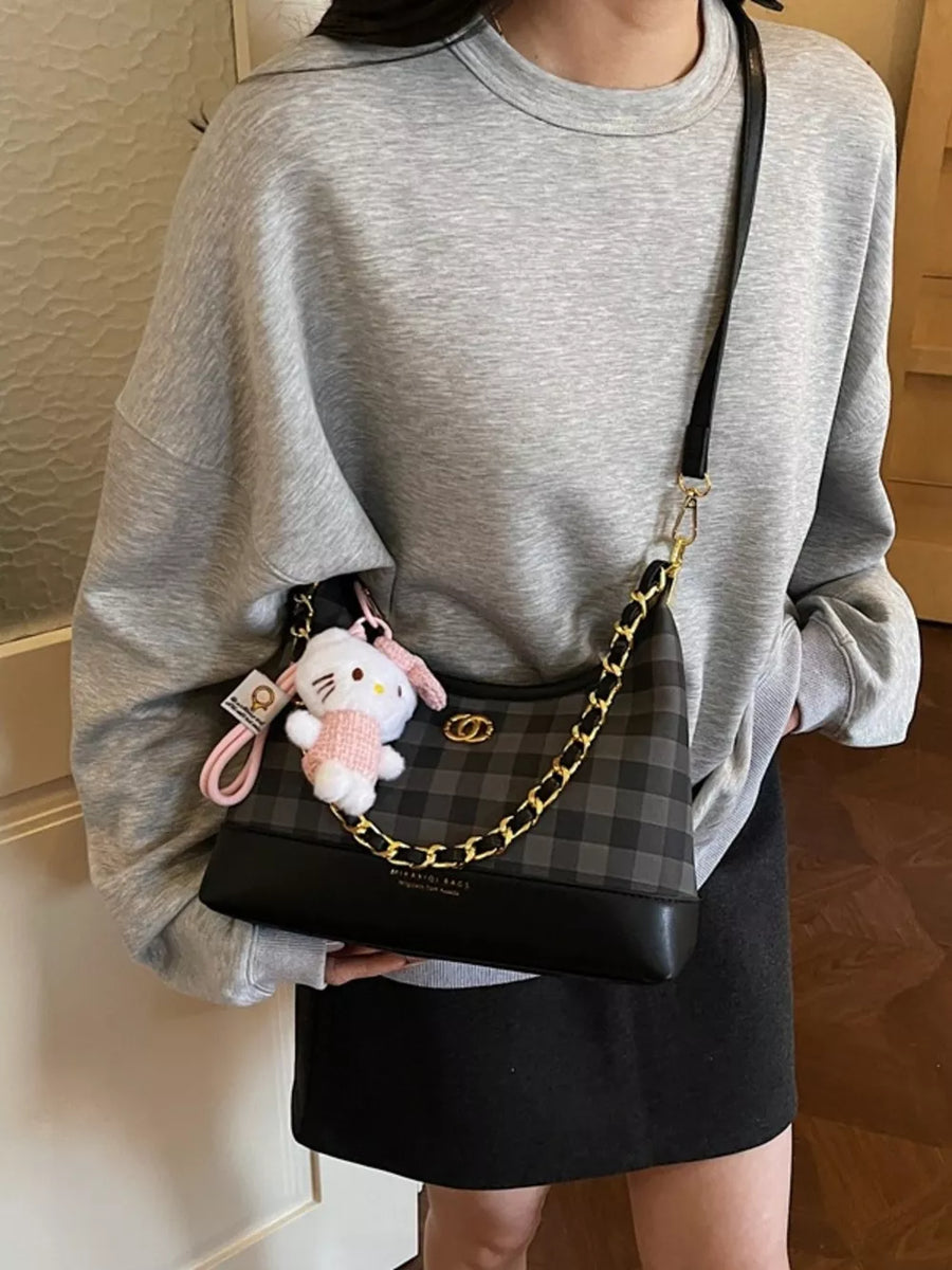 Chic plaid shoulder bag with chain accent and Hello Kitty charm