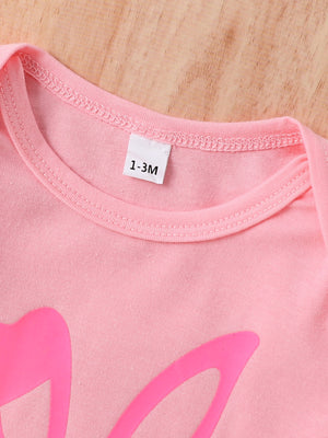 Blush pink baby bodysuit with bunny ear graphic and size tag.