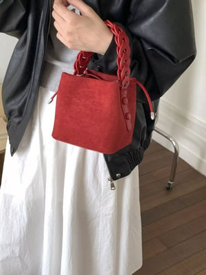 Red suede mini crossbody bag with chain strap detail