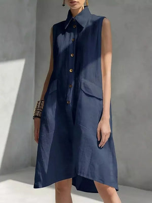 Navy blue sleeveless collared linen midi dress with button front and flap pockets.