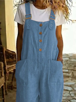 Blue wide leg romper with button front, adjustable straps and large front pockets.