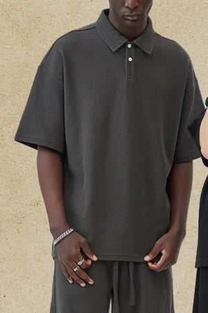Dark Gray boxy textured polo shirt with short sleeves and a two-button placket.