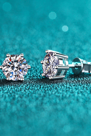 Silver six-prong moissanite stud earrings with brilliant cut stones.
