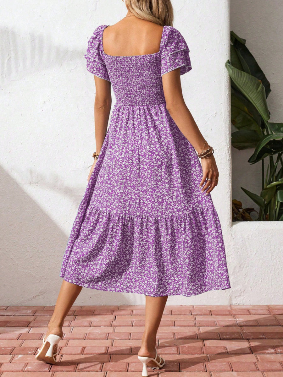 Purple floral smocked ruffle sleeve midi dress with tiered skirt.