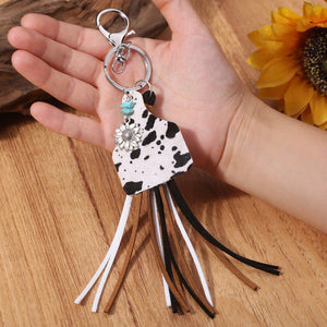 Leopard print tag keychain with flower charm, turquoise bead, and multi-color tassels.