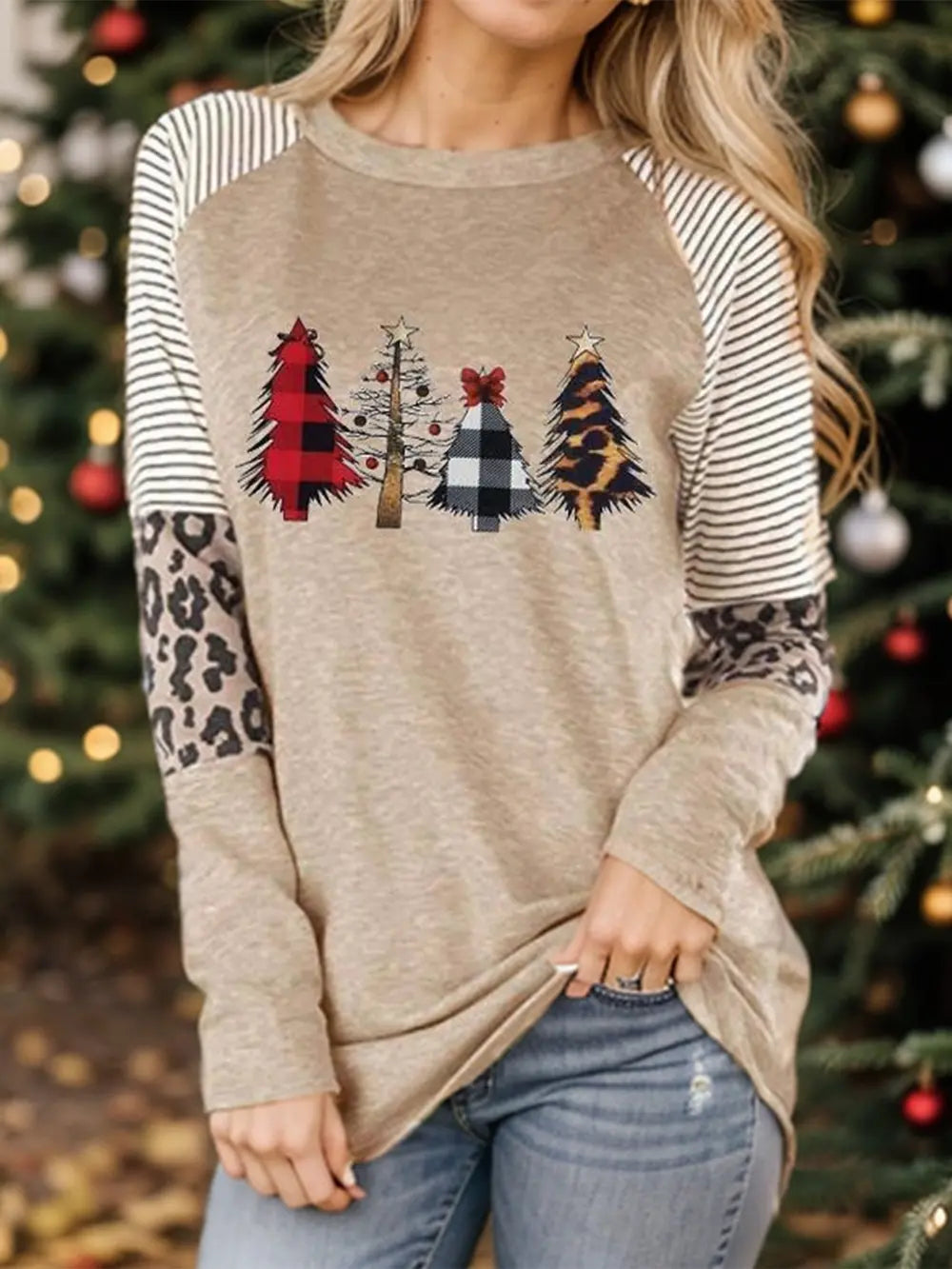 Tan raglan sleeve sweatshirt with festive Christmas tree print and leopard sleeves.