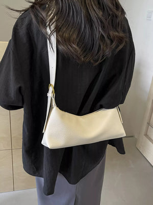 Beige minimalist PU leather crossbody bag with adjustable strap and gold hardware.
