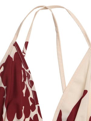 Maxi dress with deep V-neck, spaghetti straps, and a bold floral print in maroon and cream.