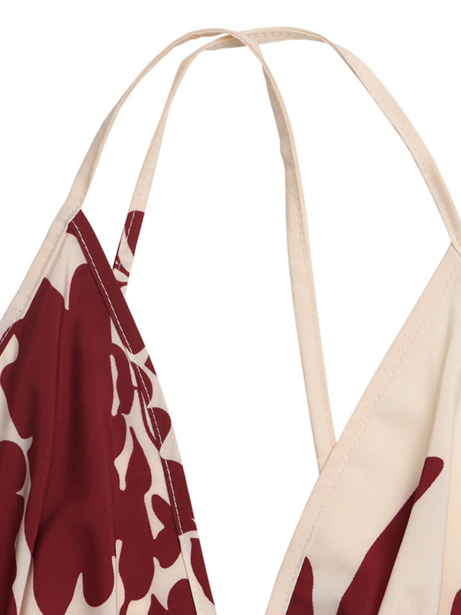 Maxi dress with deep V-neck, spaghetti straps, and a bold floral print in maroon and cream.