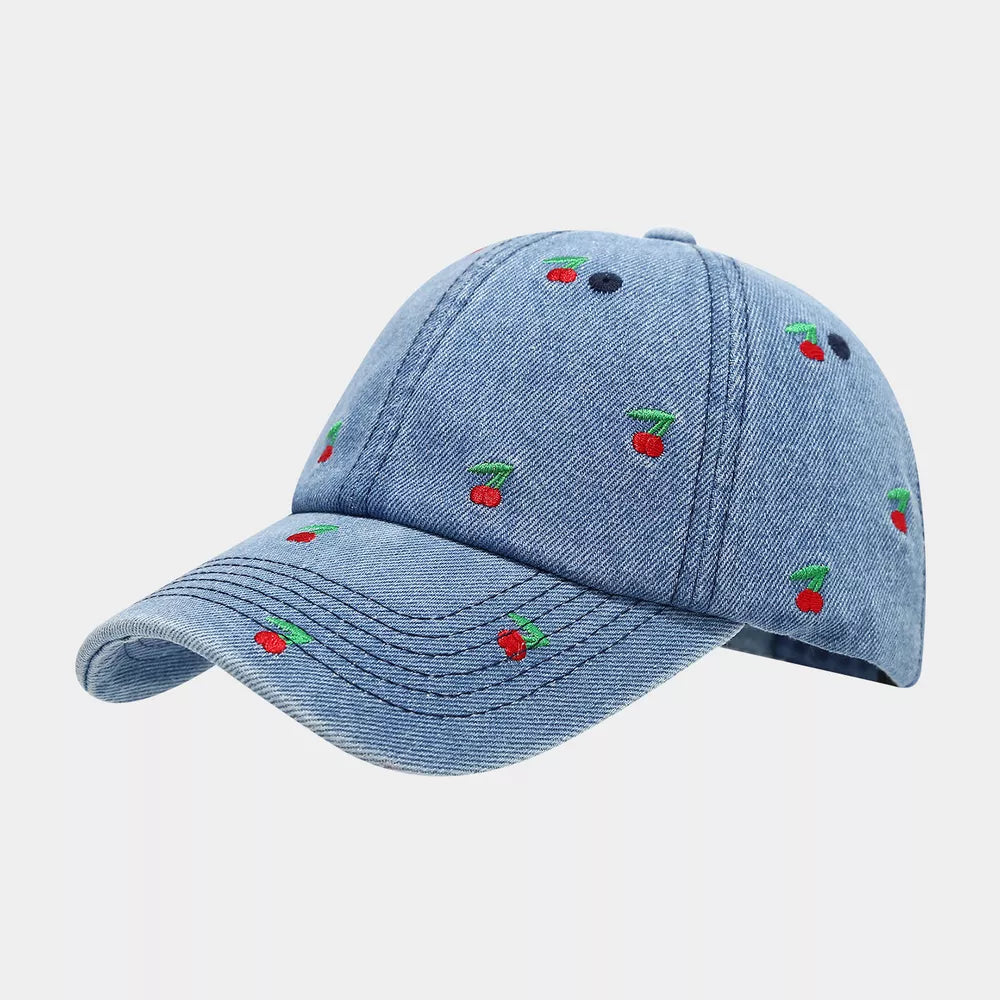 white cap featuring embroidered and cherry print