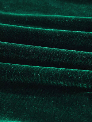 Dark green velvet fabric with subtle sparkle detail, showing textured folds.