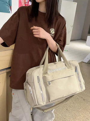 Beige canvas duffel travel bag with multiple zippered pockets and crossbody strap.