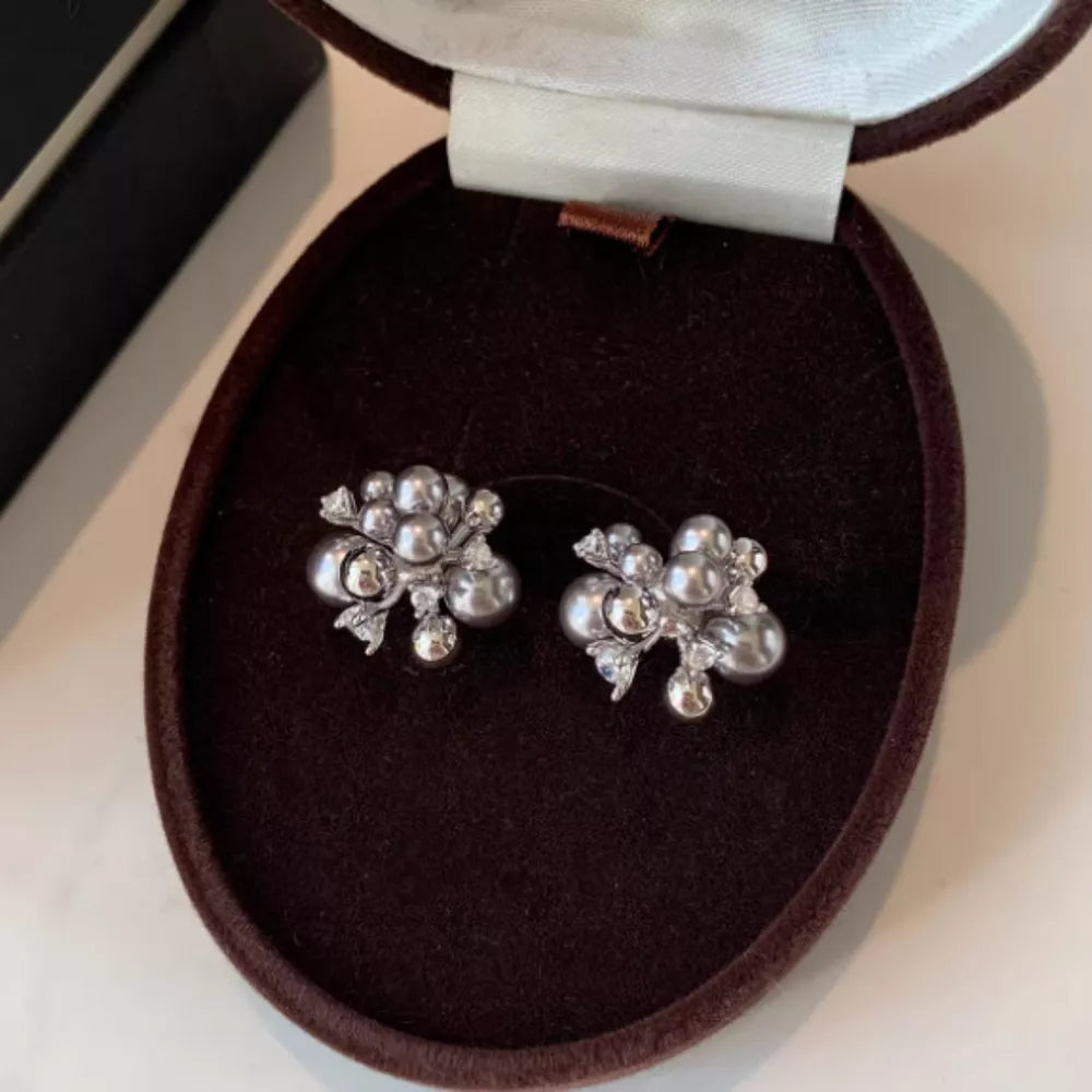 Elegant light gray pearl cluster earrings with zircon accents in a jewelry box