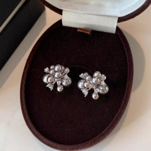 Elegant light gray pearl cluster earrings with zircon accents in a jewelry box