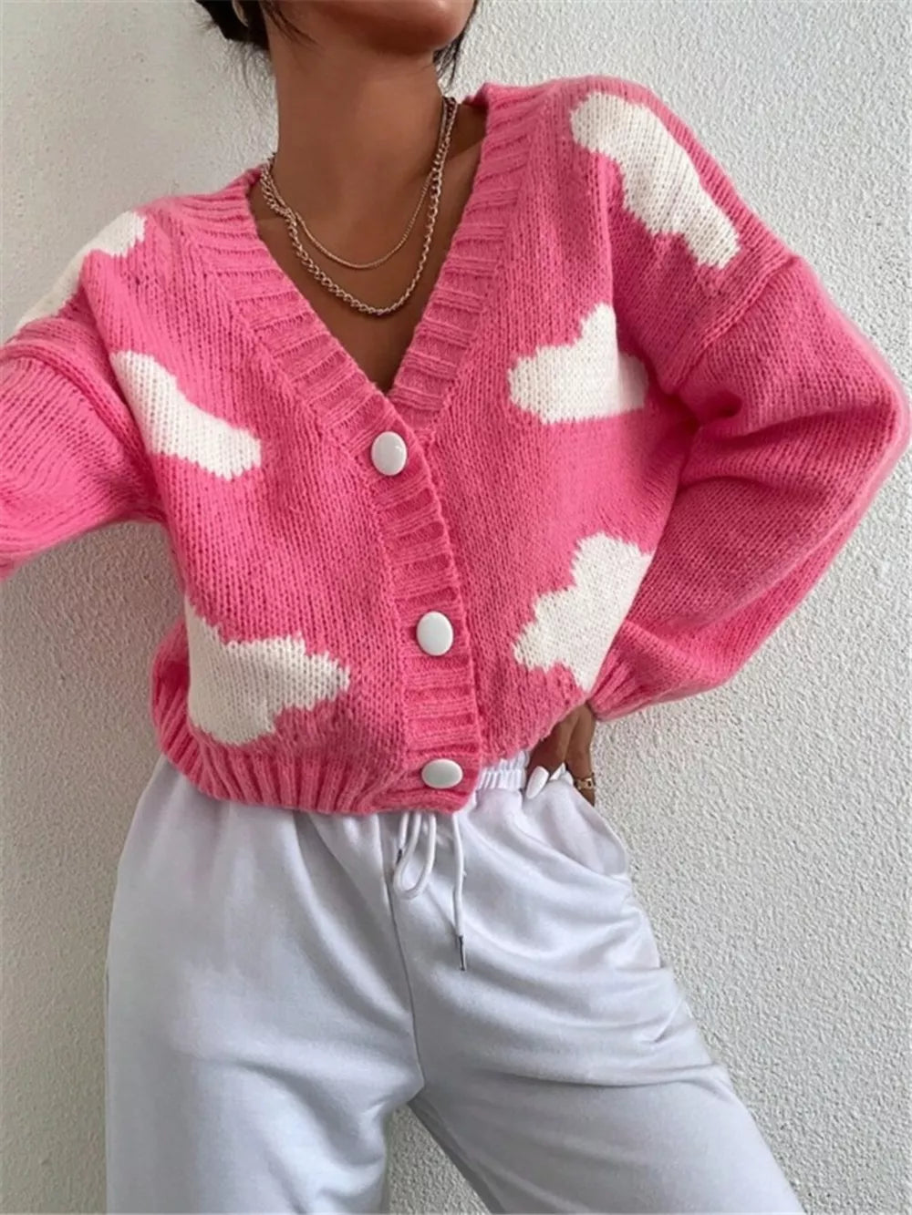 Hot pink acrylic cardigan with white cloud pattern, button front, V-neck