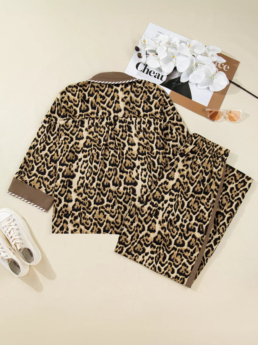 Leopard print two-piece set with buttoned shirt and pants, featuring brown trim.