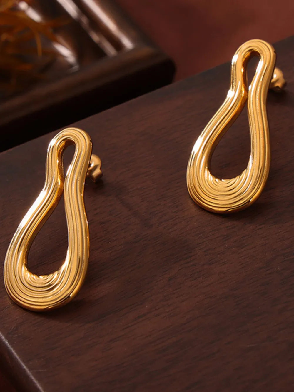 Sculptural gold-tone drop earrings with ribbed texture, 18K gold-plated.