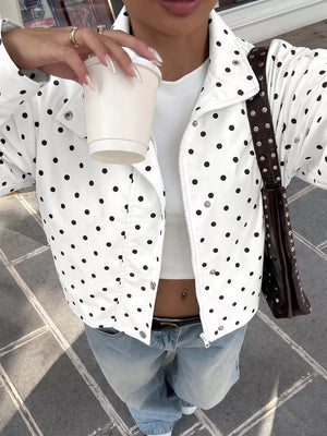 black windbreaker featuring buttoned and polka dot