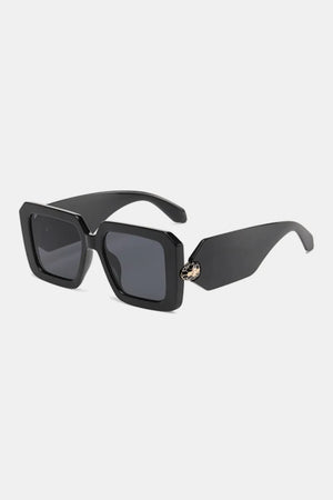 Black geometric sunglasses with a snake embellishment on the temple.