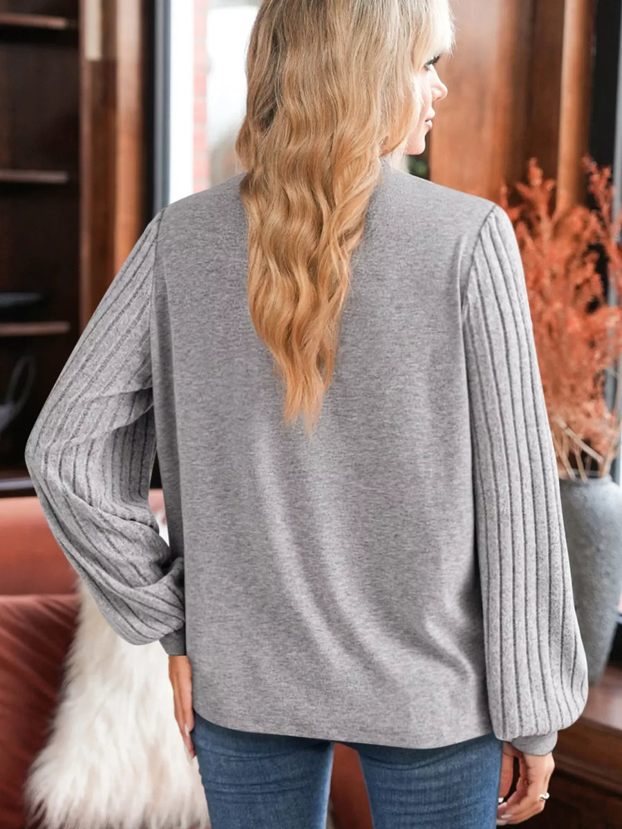 Gray ribbed knit long-sleeve top with textured sleeves and lace detail.