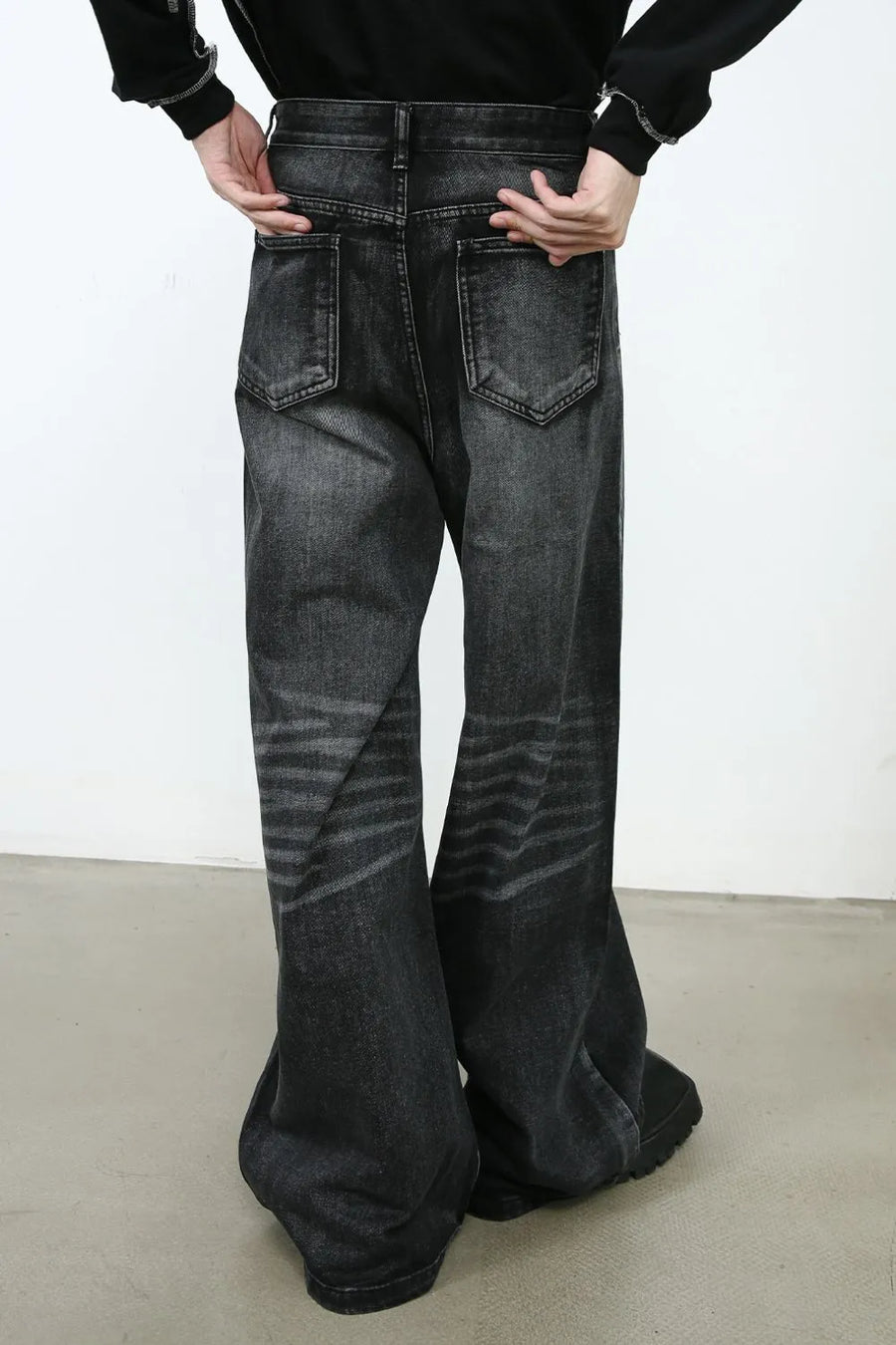 Sculpted flare denim trousers in dark wash with horizontal stripe detailing on the legs.