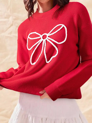 Deep red ribbed sweater with a white bow applique on the front.