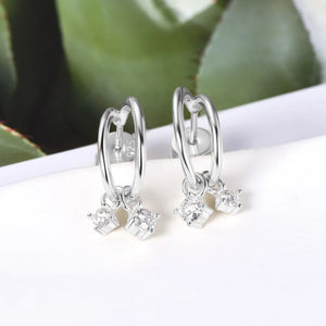 Silver hoop earrings with cubic drop charms and clear stones