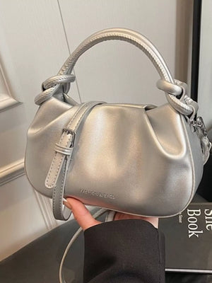 Mini ruched crossbody bag in silver with knotted handle detail and adjustable strap.