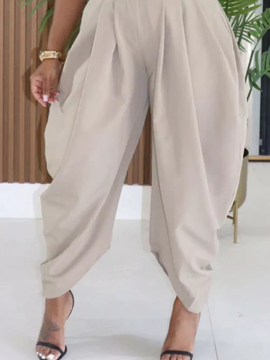 Light Khaki sculptural pleated high-waisted pants with a buttoned closure and a wide leg.