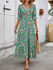 Vibrant V-neck flounce sleeve maxi dress in abstract print with tiered skirt and lace trim.
