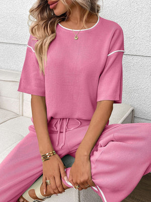 Fuchsia pink ribbed loungewear set with crew neck top and drawstring pants.