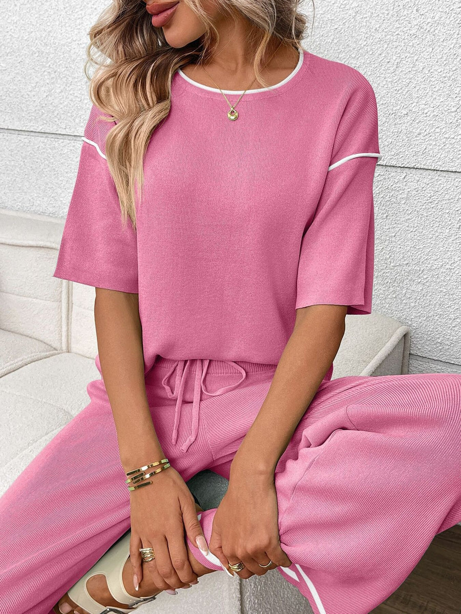 Fuchsia pink ribbed loungewear set with crew neck top and drawstring pants.