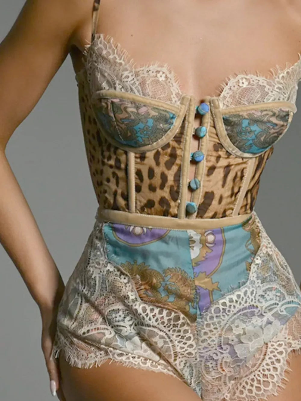 Leopard lace-trimmed romper with button details and ornate print panels.