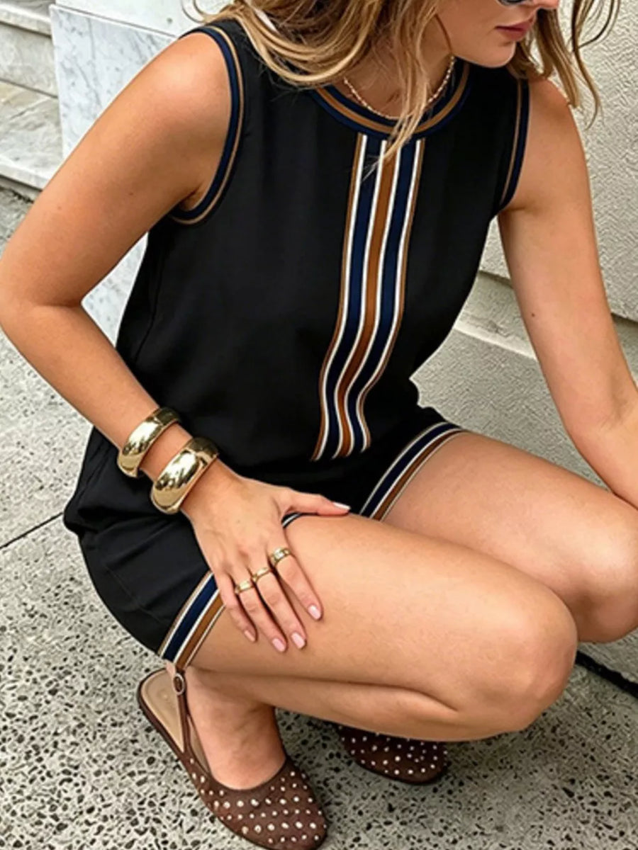 Black sleeveless romper with striped trim and gold jewelry