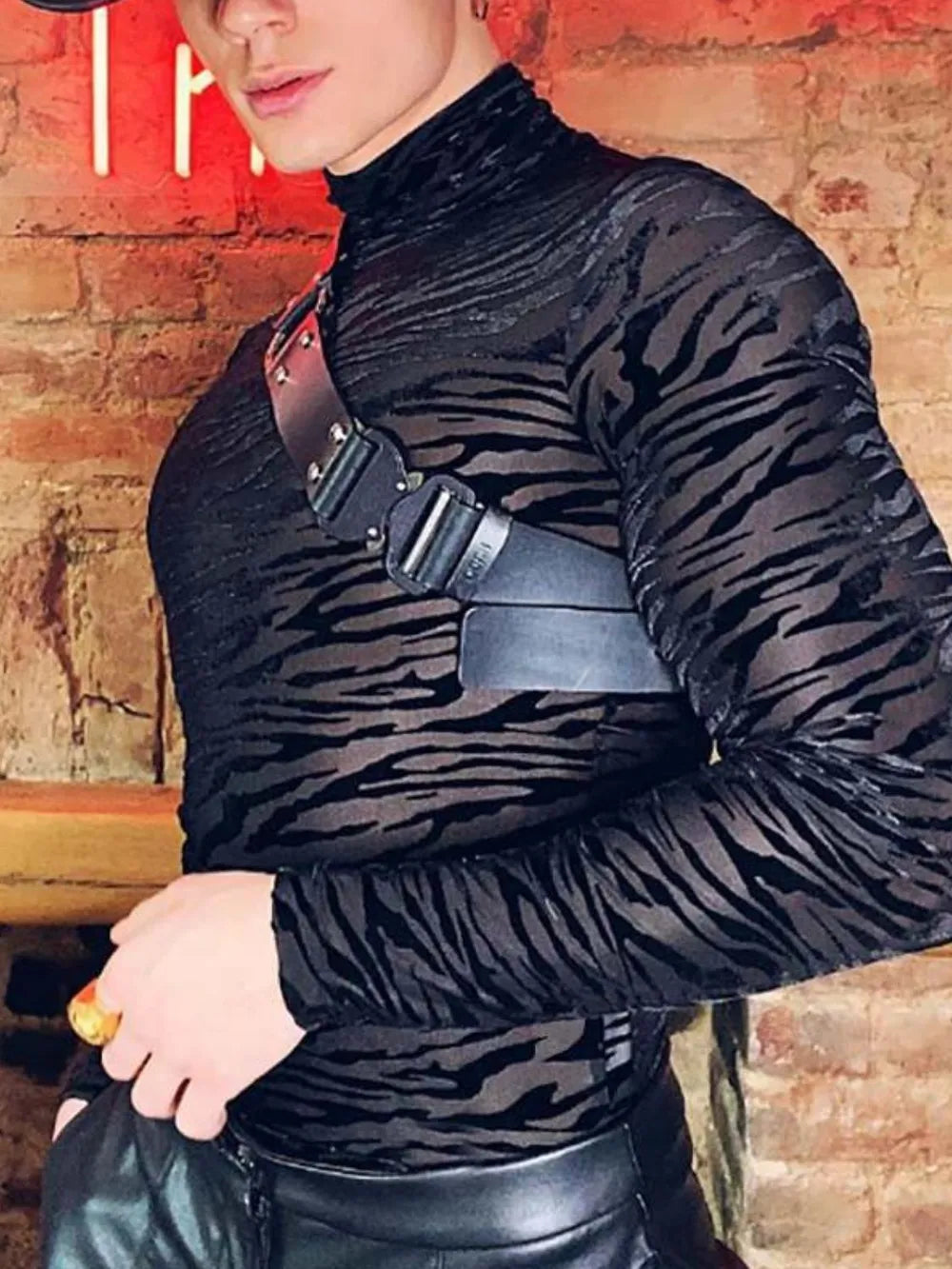 Black sheer zebra-striped mock neck long sleeve top with harness detail.
